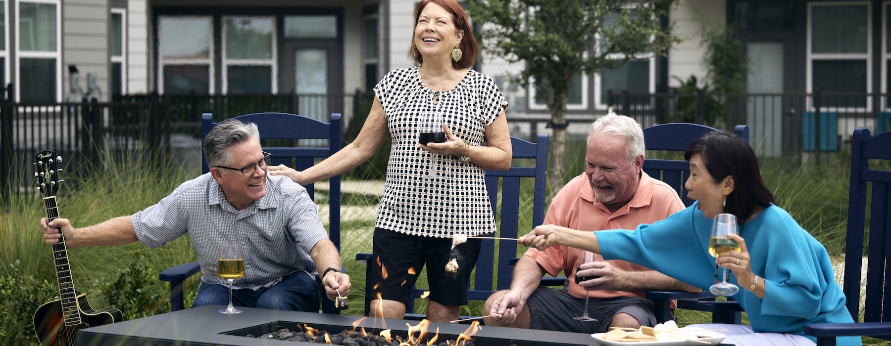 a group of people laughing around a fire