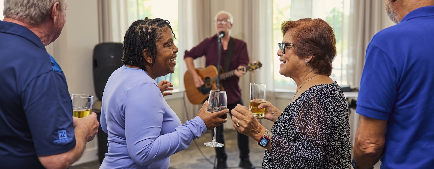 two women dancing with a glass of wine