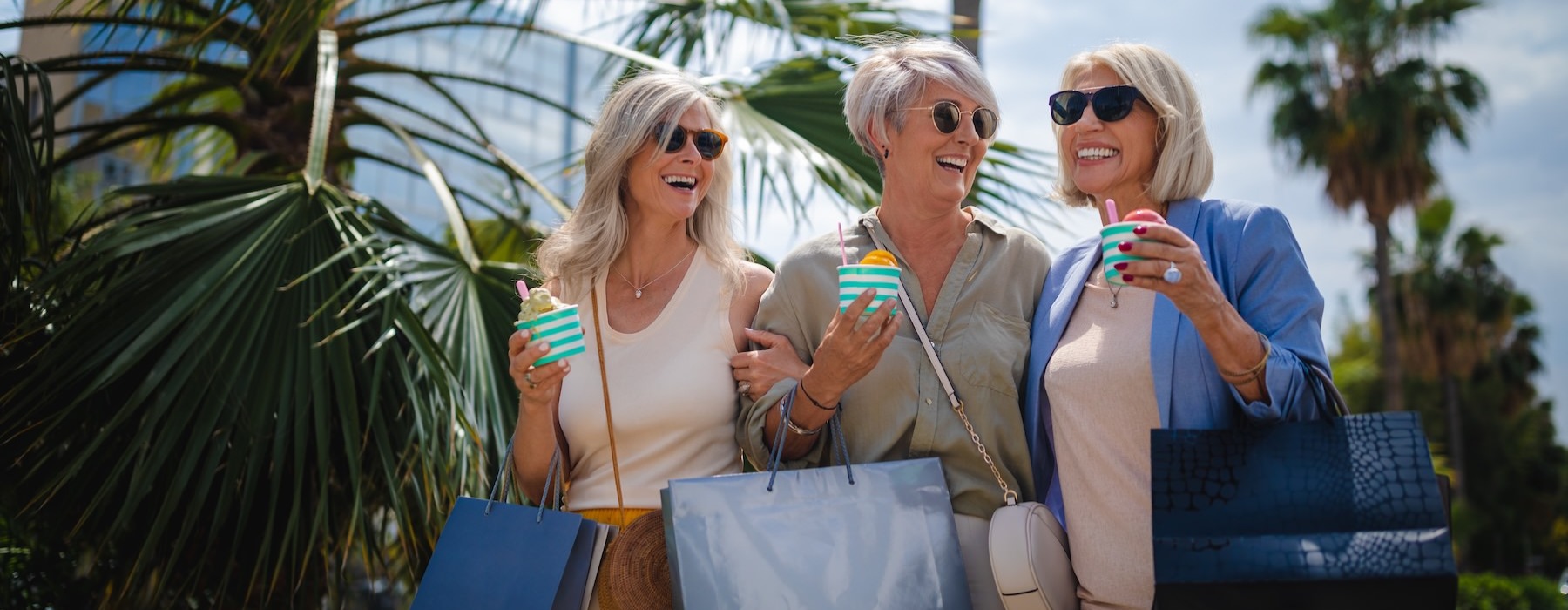 a group of women holding shopping bags